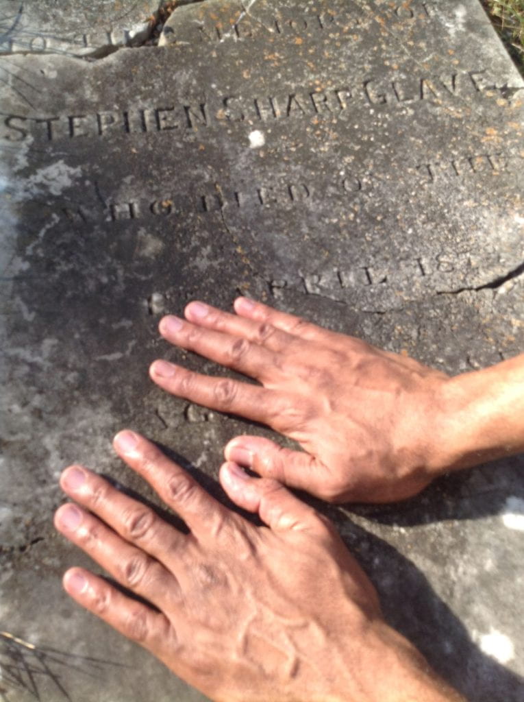 Thomas Glave's hands on Stephen Sharp Glave's Headstone